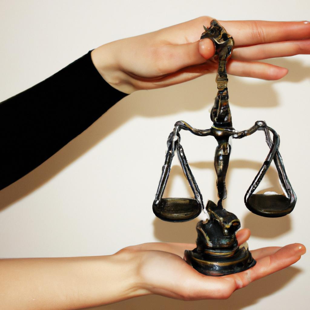 Person holding scales of justice